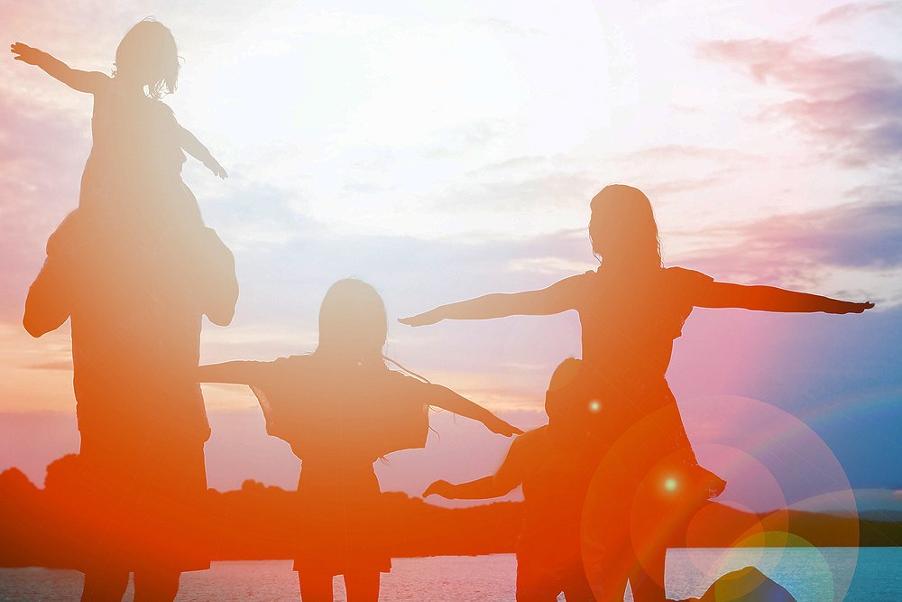 happy family by the sea on nature silhouette background